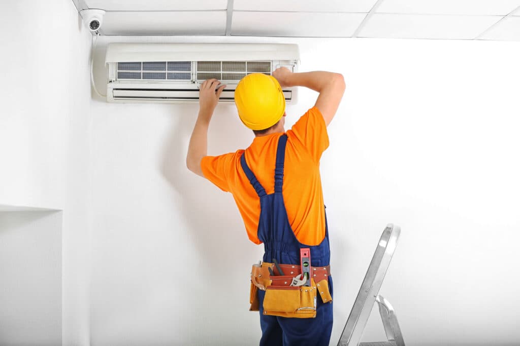 Technician servicing AC